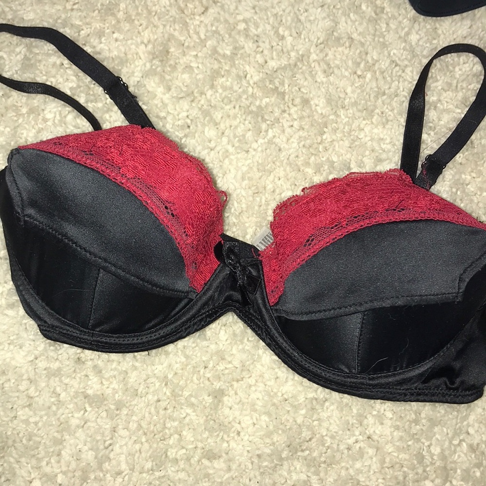 Black satin and red lace bra